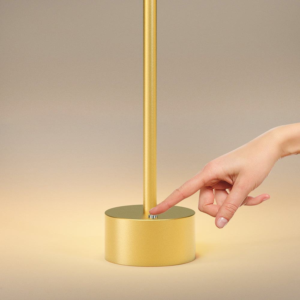 Chic gold-tone cordless LED lamp with wireless functionality for versatile interior illumination